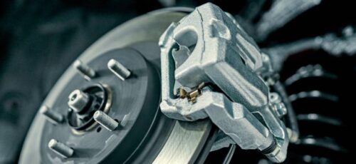Disc brake of the vehicle for repair, in process of new tire replacement. Car brake repairing in garage.Suspension of car for maintenance brakes and shock absorber systems.Close up.